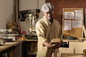 black senior man as skilled carpenter looking wood 249974 19437