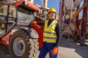 cheerful male worker standing by tractor factory 362389 5617
