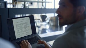 closeup businessman talking worker using laptop man with unknown colleague 723208 1306