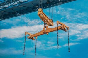 crane moves reinforced metal product with hooks yellow crane beam blue sky background 639996 55