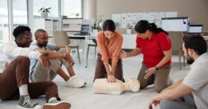 first aid cpr training group with dummy safety compliance health chest compression breathing paramedic course learning teaching people emergency rescue technique office 590464 525161 1