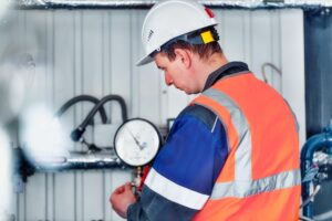 gas boiler operator helmet vest checks pressure readings manometers production 230115 3374 1