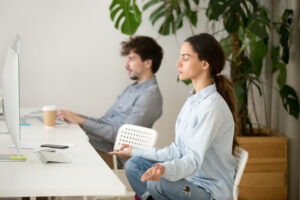 mindful calm young woman taking break office meditation