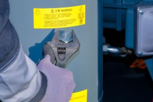 technician uses adjustable wrench fill oil into compressor 1089554 37473