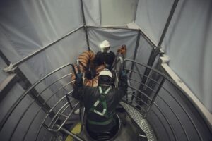 top view male climb up stairs into tank stainless chemical area confined space safety blower fresh air 478515 6070