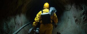 worker protective gear moves through dark tunnel person wears yellow suit helmet safety 1299716 17108